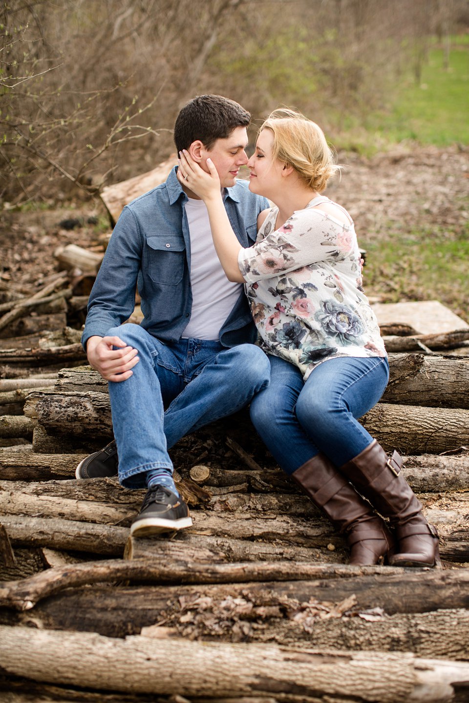 Spring engagement photographs on woodpile