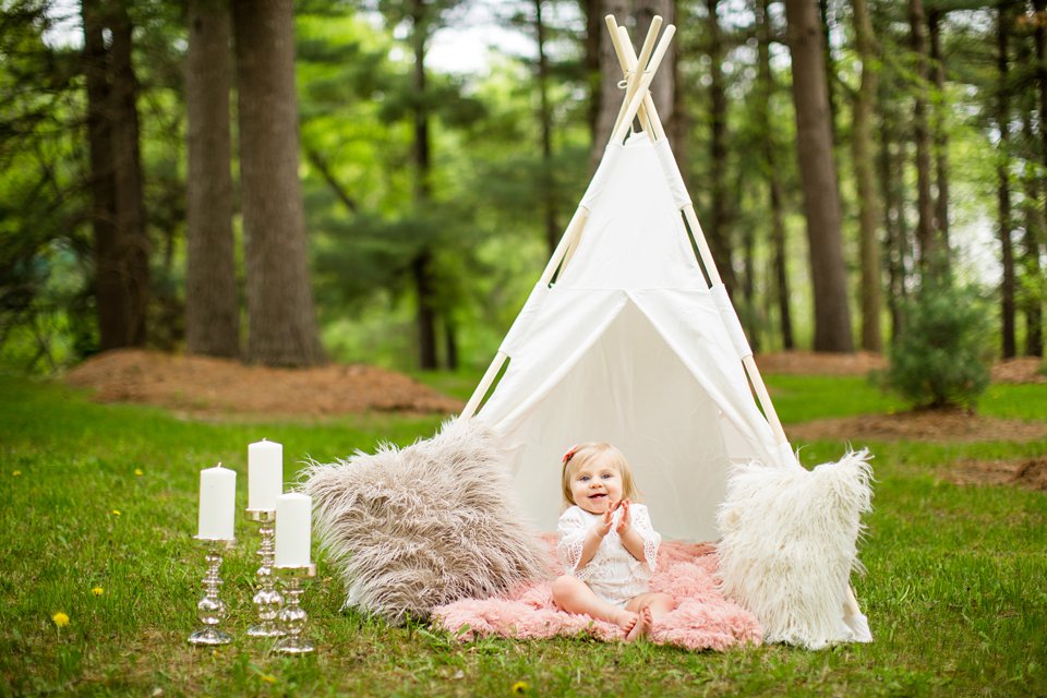 Photographs of a toddler under a teepee with fuzzy pillows