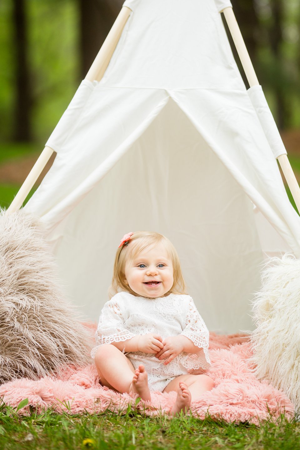 Photographs of a toddler under a teepee with fuzzy pillows