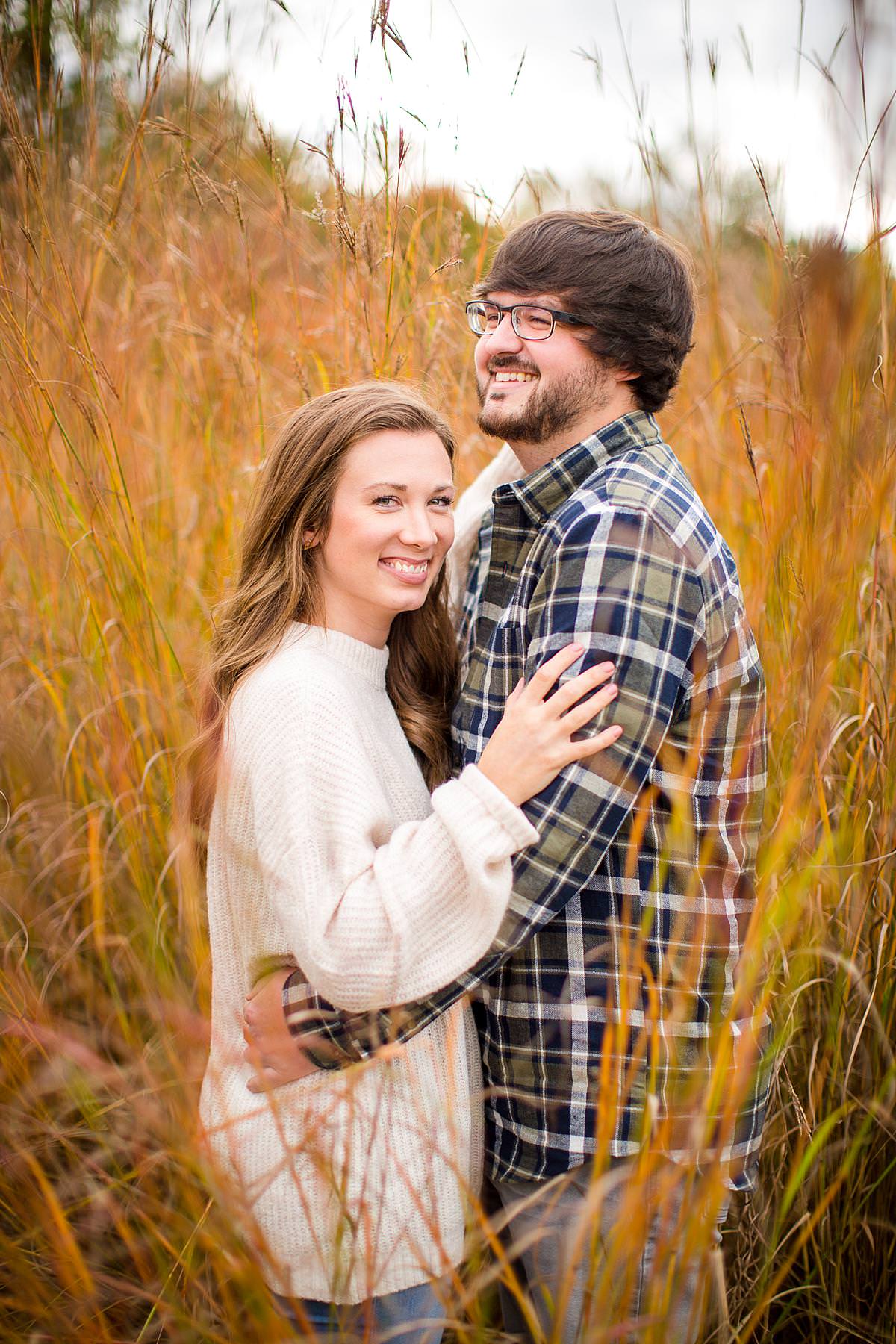 Fall engagement photographs in tall red grass, Grand Ledge, Michigan