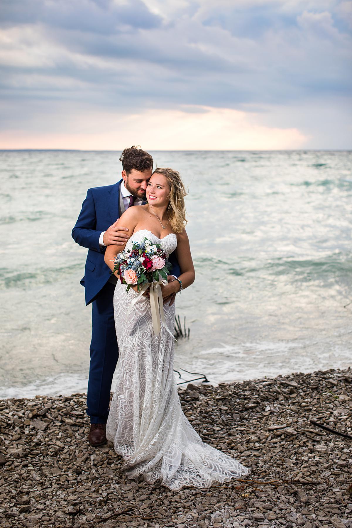 Destination wedding photographs in Mackinaw City, Michigan at the beach