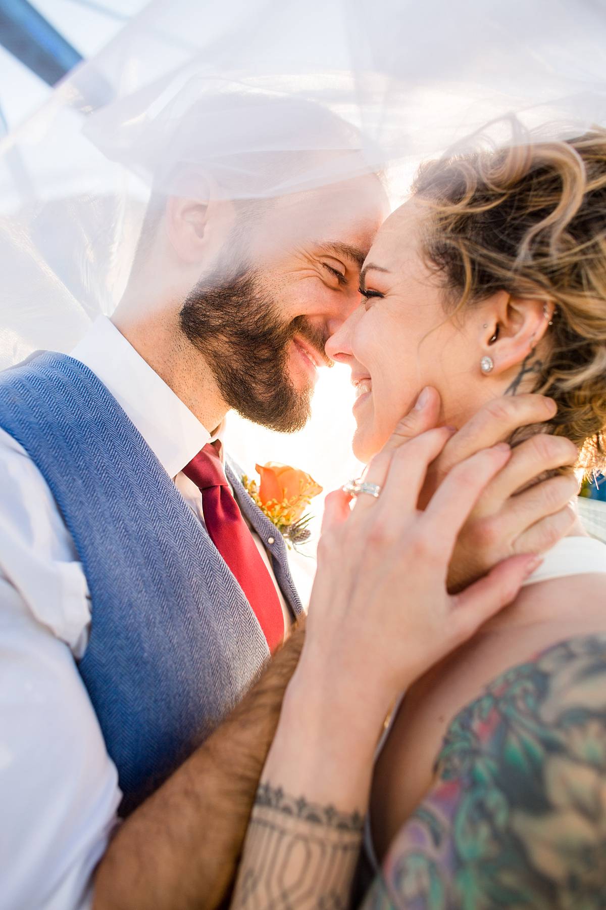 Wedding photographs of a smiling bride and groom at the Grand Rapids Blue Bridge