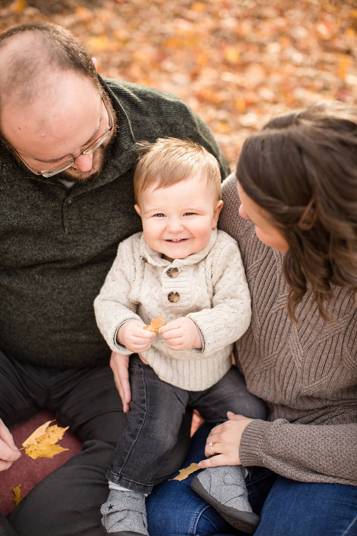 Toddler laughing during fall family photographs at Lincoln Brick Park in Grand Ledge, Michigan