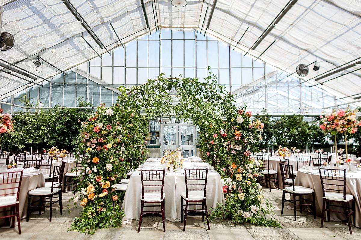 MSU with incredible floral arch in the Michigan State University Horticulture Garden Greenhouse reception area