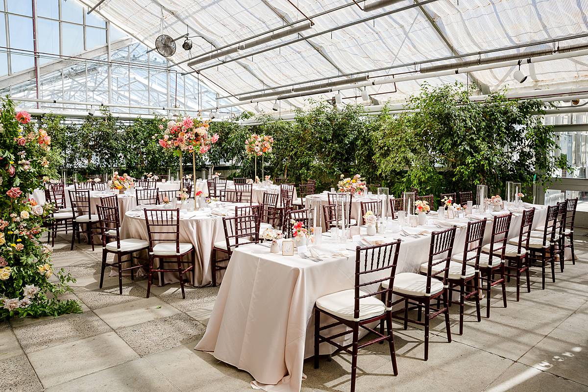 MSU wedding with incredible floral arch in the Michigan State University Horticulture Garden Greenhouse reception area